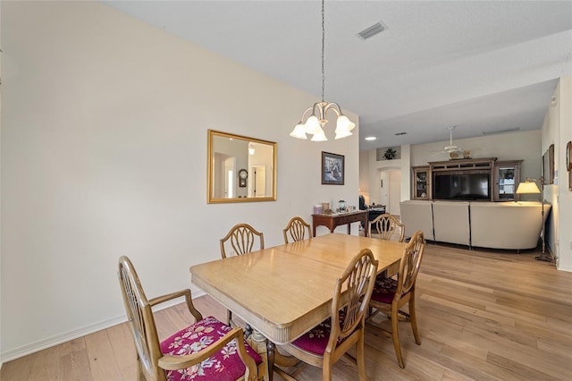 1417 Forest Acres Dr, The Villages, FL 32162 - dining space featuring visible vents, baseboards, light wood-type flooring, and an inviting chandelier