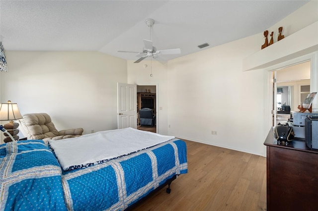 1417 Forest Acres Dr, The Villages, FL 32162 - bedroom with wood finished floors, baseboards, visible vents, ceiling fan, and vaulted ceiling