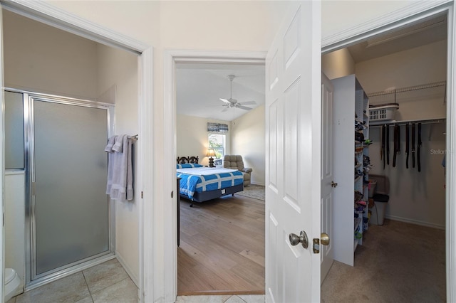 1417 Forest Acres Dr, The Villages, FL 32162 - ensuite bathroom featuring ensuite bath, a spacious closet, a stall shower, and a ceiling fan