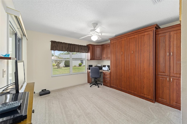 1417 Forest Acres Dr, The Villages, FL 32162 - office space featuring baseboards, carpet floors, a textured ceiling, built in study area, and a ceiling fan
