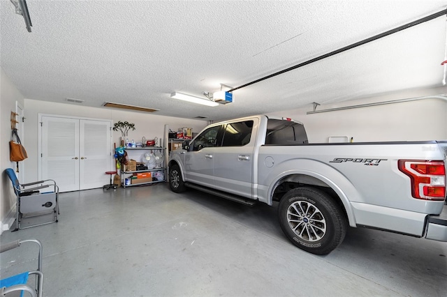 1417 Forest Acres Dr, The Villages, FL 32162 - garage with a garage door opener and visible vents