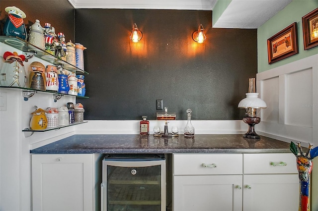bar featuring wine cooler and a dry bar
