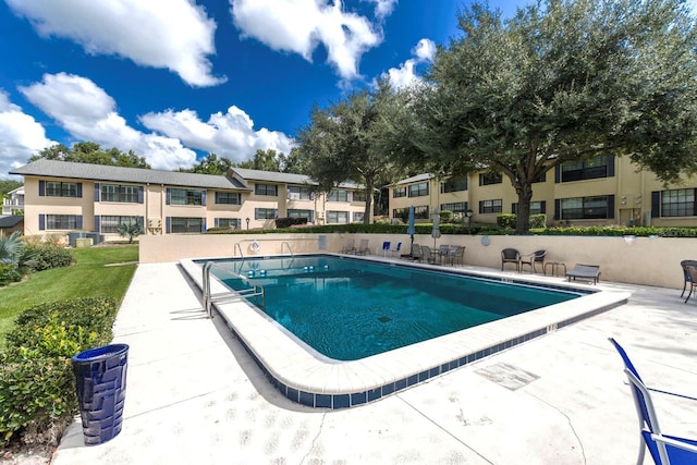 community pool featuring a patio and fence