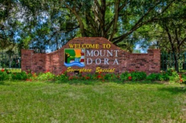 community / neighborhood sign featuring a yard