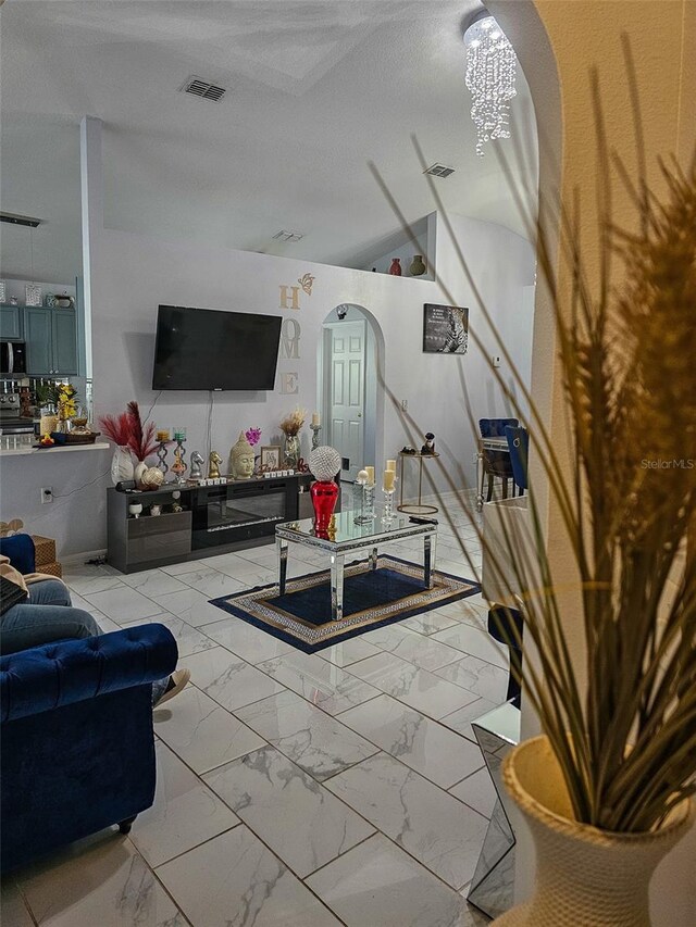 2442 Foxhollow Rd, Tavares, FL 32778 - living room featuring marble finish floor, visible vents, arched walkways, and a textured ceiling