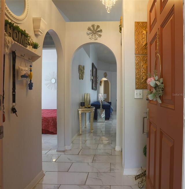 2442 Foxhollow Rd, Tavares, FL 32778 - corridor with marble finish floor, baseboards, and arched walkways