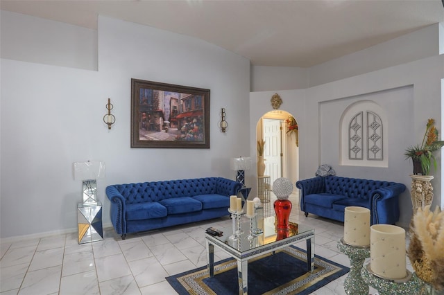 2442 Foxhollow Rd, Tavares, FL 32778 - living room featuring marble finish floor, baseboards, and arched walkways