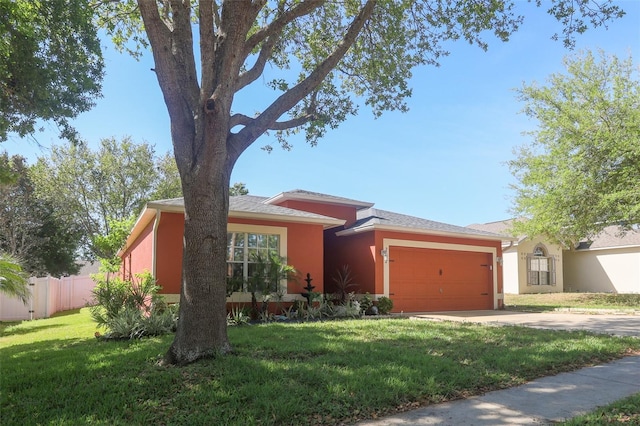 2442 Foxhollow Rd, Tavares, FL 32778 - ranch-style home featuring fence, a garage, stucco siding, a front yard, and driveway