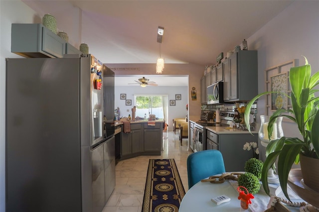 2442 Foxhollow Rd, Tavares, FL 32778 - kitchen featuring vaulted ceiling, tasteful backsplash, appliances with stainless steel finishes, a peninsula, and ceiling fan