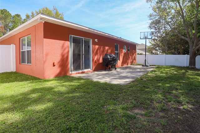2442 Foxhollow Rd, Tavares, FL 32778 - rear view of house featuring stucco siding, fence, a yard, and a patio area