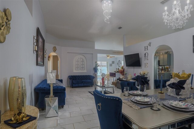2442 Foxhollow Rd, Tavares, FL 32778 - dining room featuring arched walkways, marble finish floor, visible vents, and ceiling fan with notable chandelier