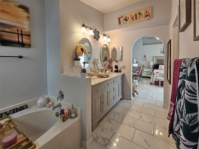 2442 Foxhollow Rd, Tavares, FL 32778 - ensuite bathroom featuring marble finish floor, ensuite bath, vanity, and a garden tub