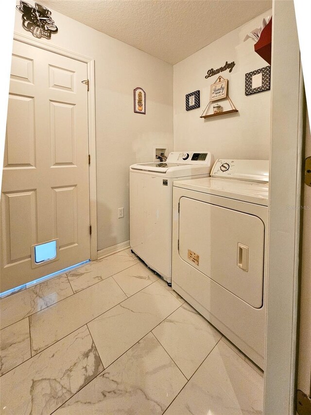 2442 Foxhollow Rd, Tavares, FL 32778 - washroom with marble finish floor, a textured ceiling, independent washer and dryer, and laundry area