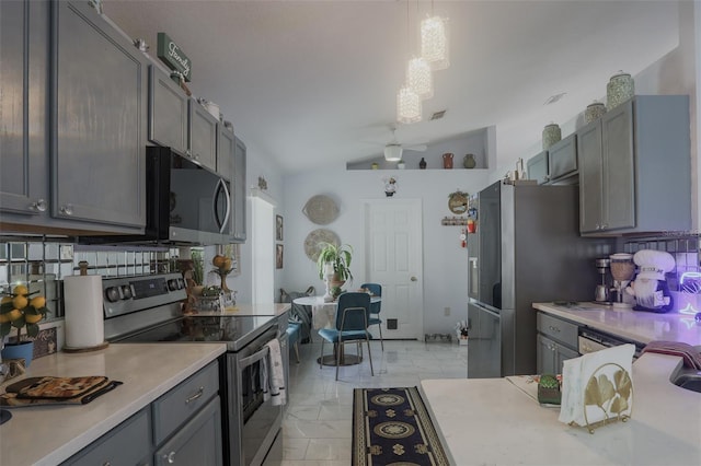 2442 Foxhollow Rd, Tavares, FL 32778 - kitchen featuring vaulted ceiling, light countertops, gray cabinetry, stainless steel appliances, and marble finish floor
