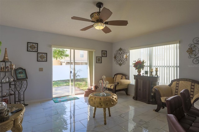 2442 Foxhollow Rd, Tavares, FL 32778 - living room with marble finish floor, baseboards, and ceiling fan