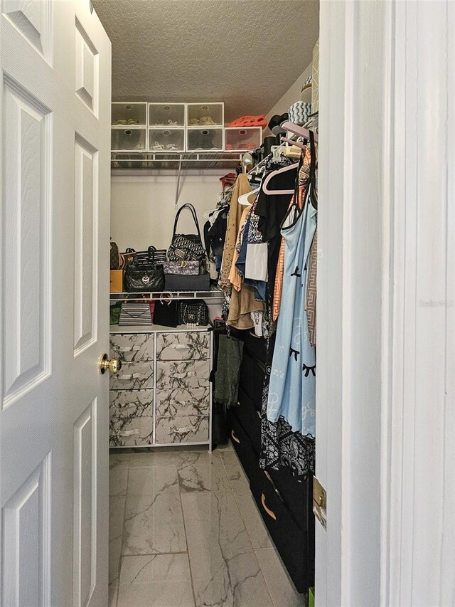 2442 Foxhollow Rd, Tavares, FL 32778 - walk in closet with marble finish floor