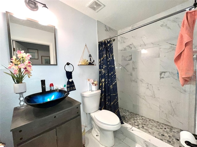 2442 Foxhollow Rd, Tavares, FL 32778 - bathroom featuring visible vents, marble finish floor, a tile shower, toilet, and vanity