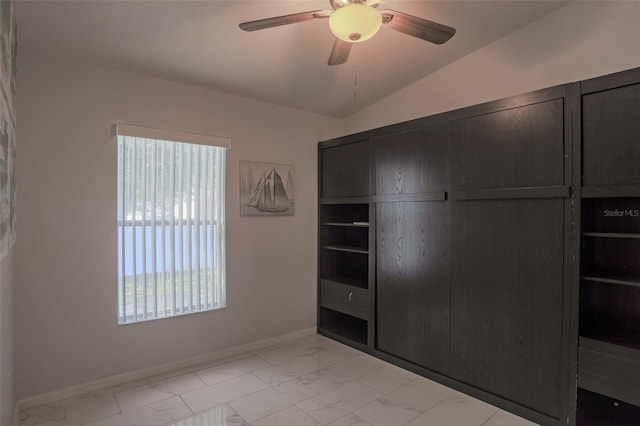 2442 Foxhollow Rd, Tavares, FL 32778 - unfurnished bedroom featuring vaulted ceiling, a closet, marble finish floor, baseboards, and ceiling fan
