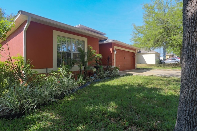 2442 Foxhollow Rd, Tavares, FL 32778 - view of front of property with stucco siding, concrete driveway, a garage, and a front lawn