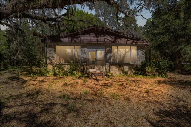 801 Kilgore St, Wildwood, FL 34785 - rear view of house with a sunroom