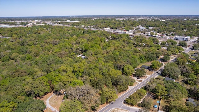 801 Kilgore St, Wildwood, FL 34785 - drone / aerial view featuring a wooded view