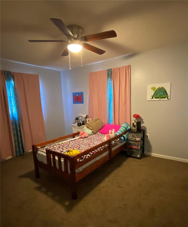 carpeted bedroom with baseboards and a ceiling fan