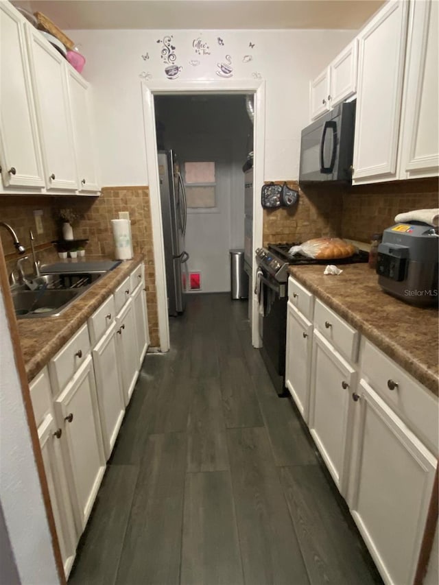 kitchen featuring white cabinetry, black appliances, a sink, and dark wood-type flooring