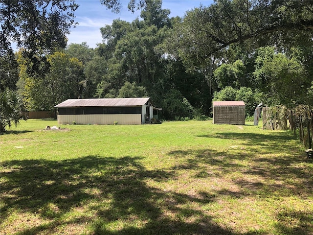 136 S Commercial St, Coleman, FL 33521 - view of yard with an outbuilding, a view of trees, and an outdoor structure