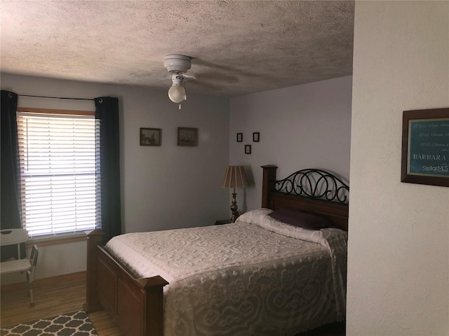 136 S Commercial St, Coleman, FL 33521 - bedroom featuring light wood-type flooring, multiple windows, a textured ceiling, and a ceiling fan