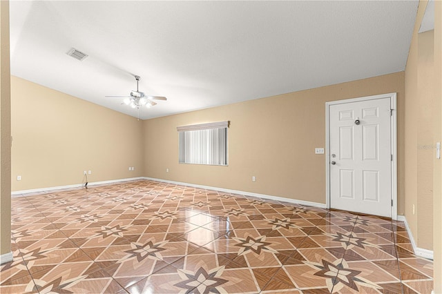 spare room featuring visible vents, baseboards, lofted ceiling, and ceiling fan