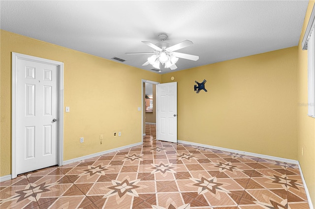 unfurnished room featuring visible vents, baseboards, and ceiling fan