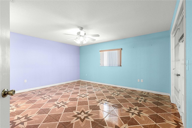 interior space featuring a closet, a textured ceiling, baseboards, and a ceiling fan
