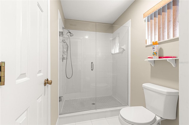 bathroom featuring toilet and a stall shower