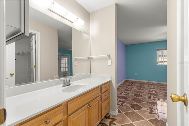 bathroom featuring vanity and baseboards