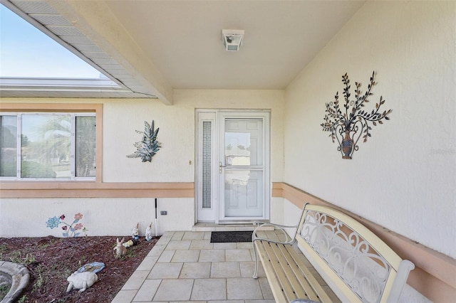 view of exterior entry with stucco siding