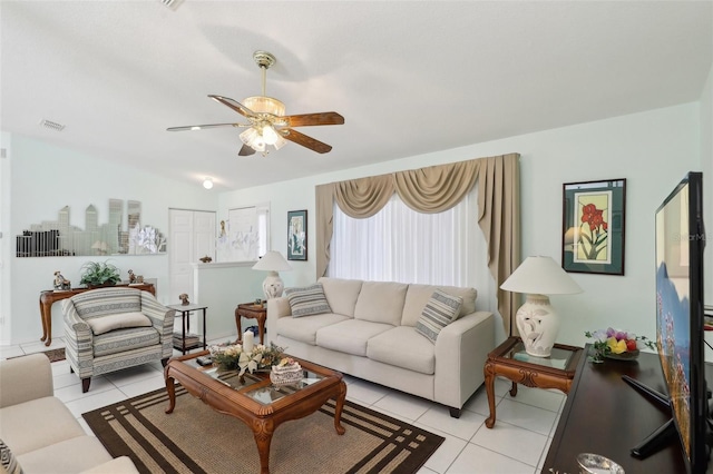 living room with light tile patterned flooring, visible vents, and ceiling fan