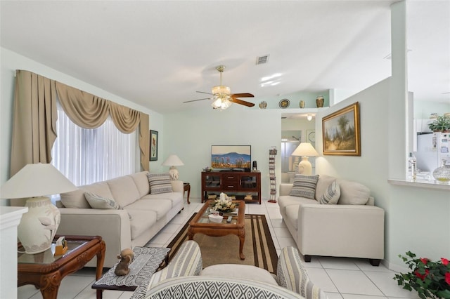 living room featuring light tile patterned flooring, visible vents, lofted ceiling, and ceiling fan