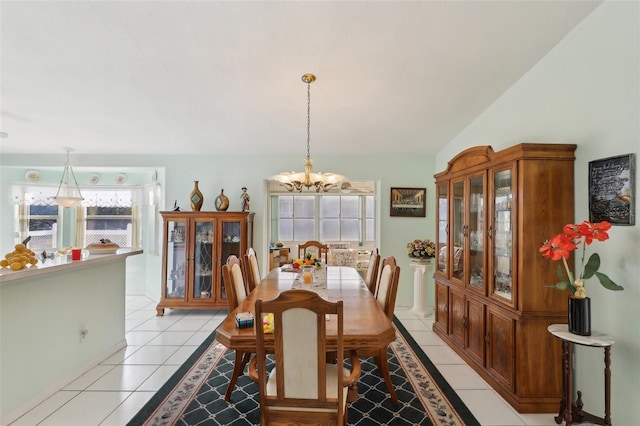 dining area featuring a notable chandelier and light tile patterned floors