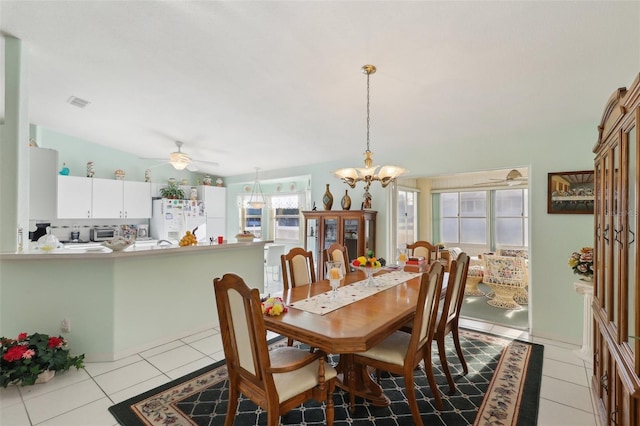 dining area featuring light tile patterned flooring, ceiling fan with notable chandelier, visible vents, and a baseboard heating unit