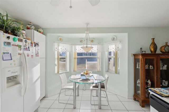 dining space featuring light tile patterned floors and ceiling fan
