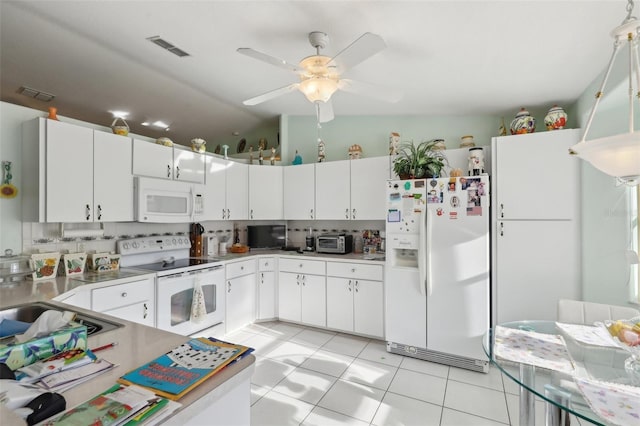 kitchen featuring white cabinets, light countertops, visible vents, and white appliances