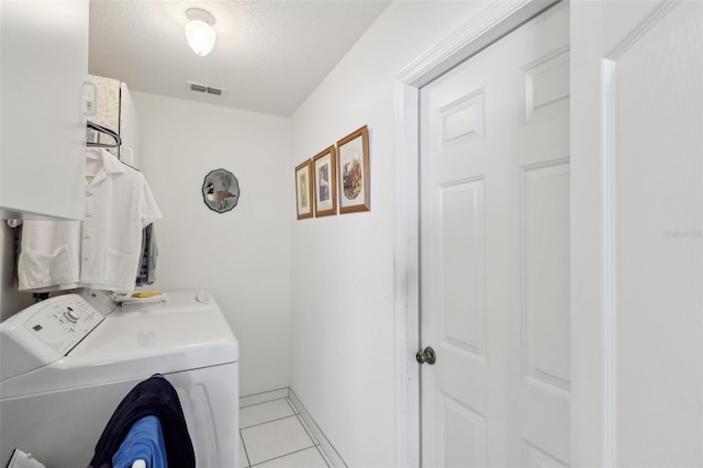 laundry room with separate washer and dryer, a textured ceiling, laundry area, light tile patterned floors, and visible vents