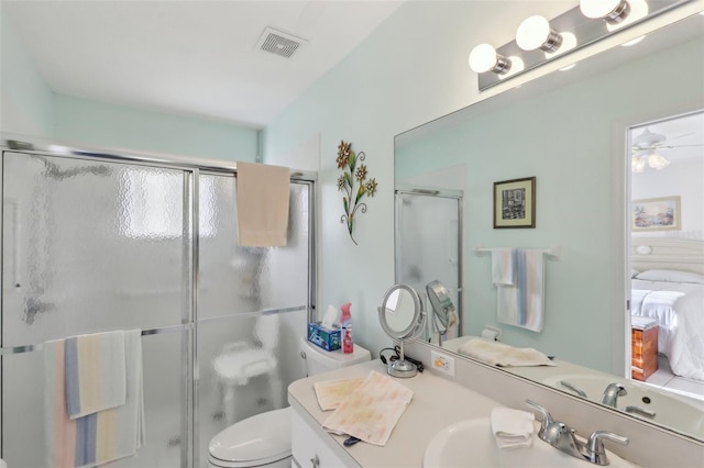 ensuite bathroom with visible vents, toilet, vanity, a stall shower, and ensuite bath