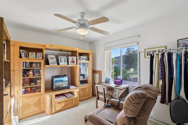 living area featuring a ceiling fan and light colored carpet