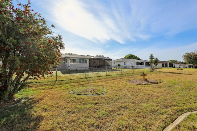 view of yard with a sunroom and fence