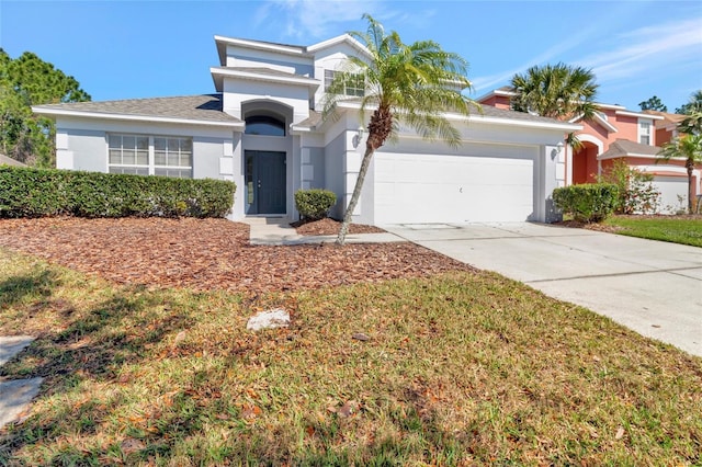view of front of property featuring stucco siding, an attached garage, and concrete driveway