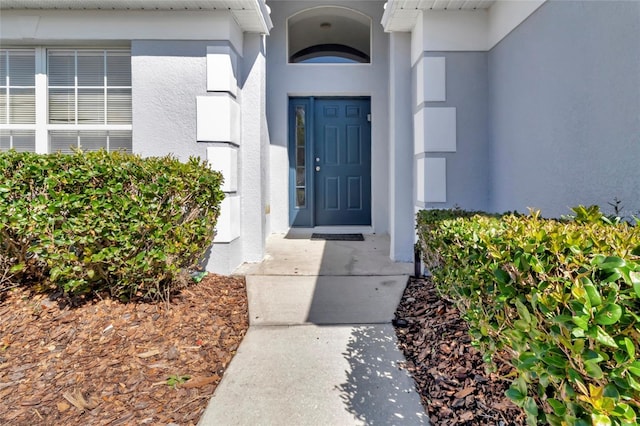 doorway to property with stucco siding