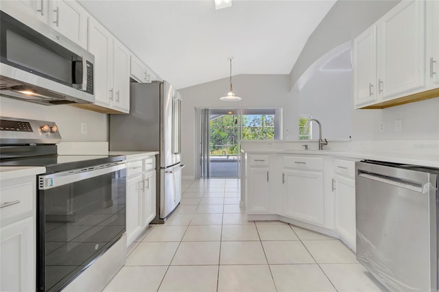 kitchen featuring light tile patterned floors, appliances with stainless steel finishes, white cabinets, and light countertops