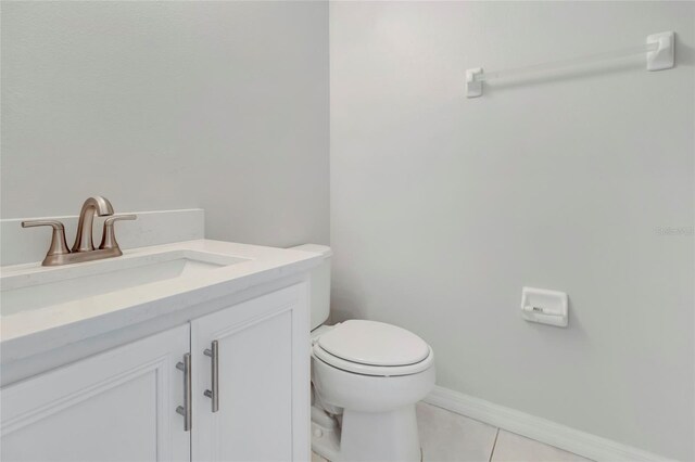 bathroom with vanity, tile patterned floors, toilet, and baseboards