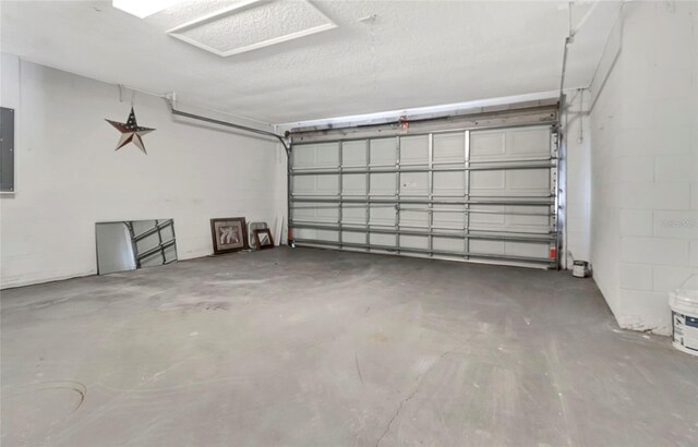 garage with concrete block wall and electric panel